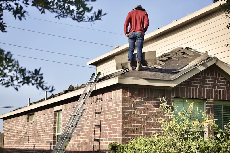 Professional roofer working on a residential roof in Emmett